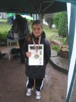 Alina zeigt stolz Urkunde und Medaille für ihren Sieg im 50m Lauf.